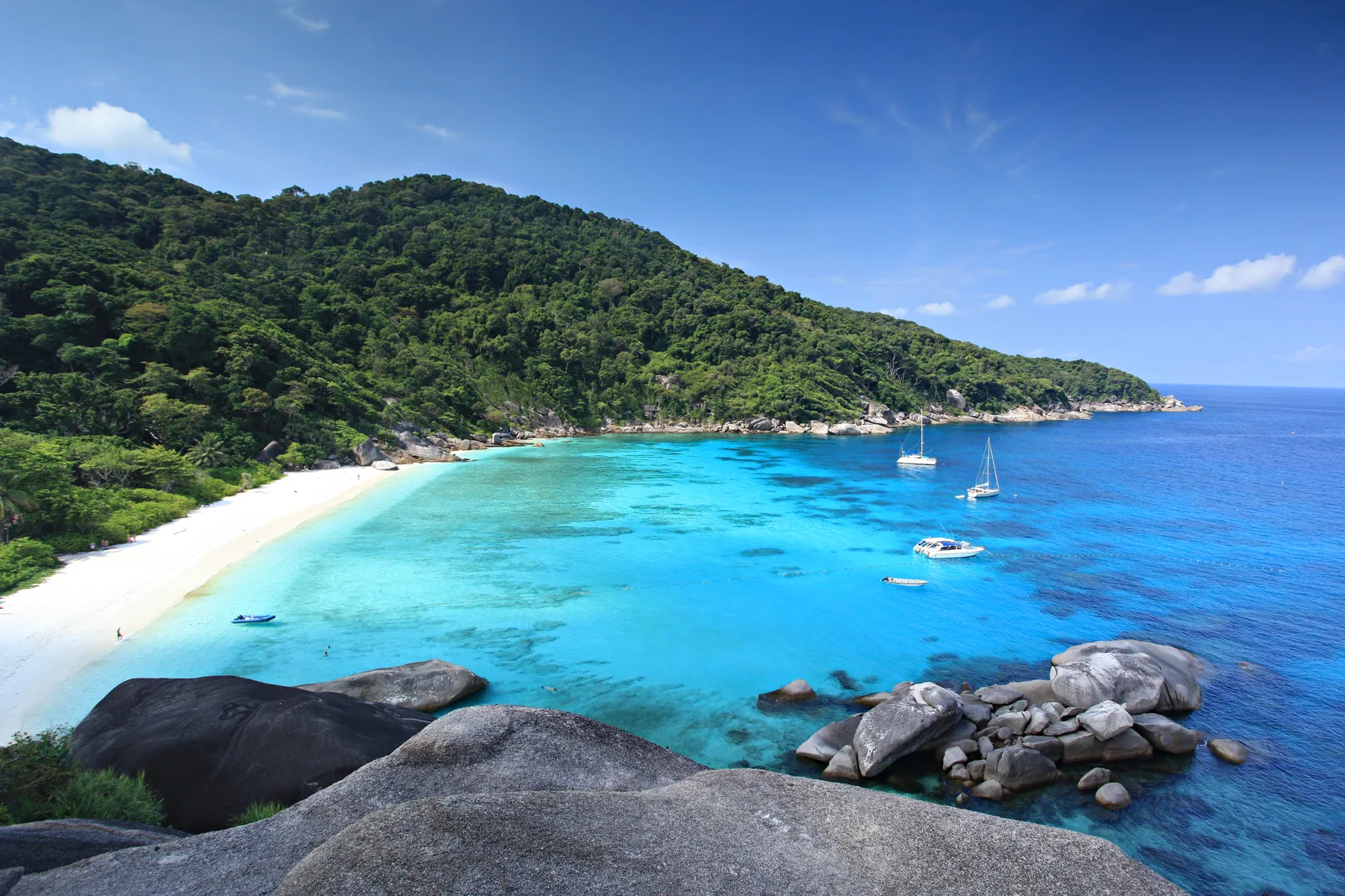 White sand beach and clear turquoise water seen from granite boulders in Mu Ko Similan National Park, Phang Nga, Thailand